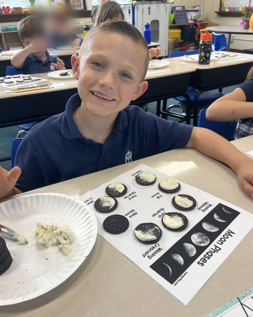 student with moon phases work sheet at desk and oreo cookies