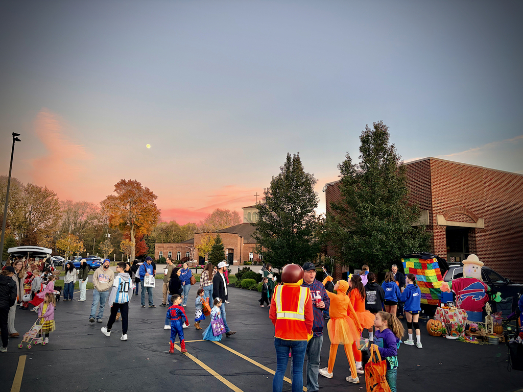 parking lot of school with students and parents dressed up for trunk or treat