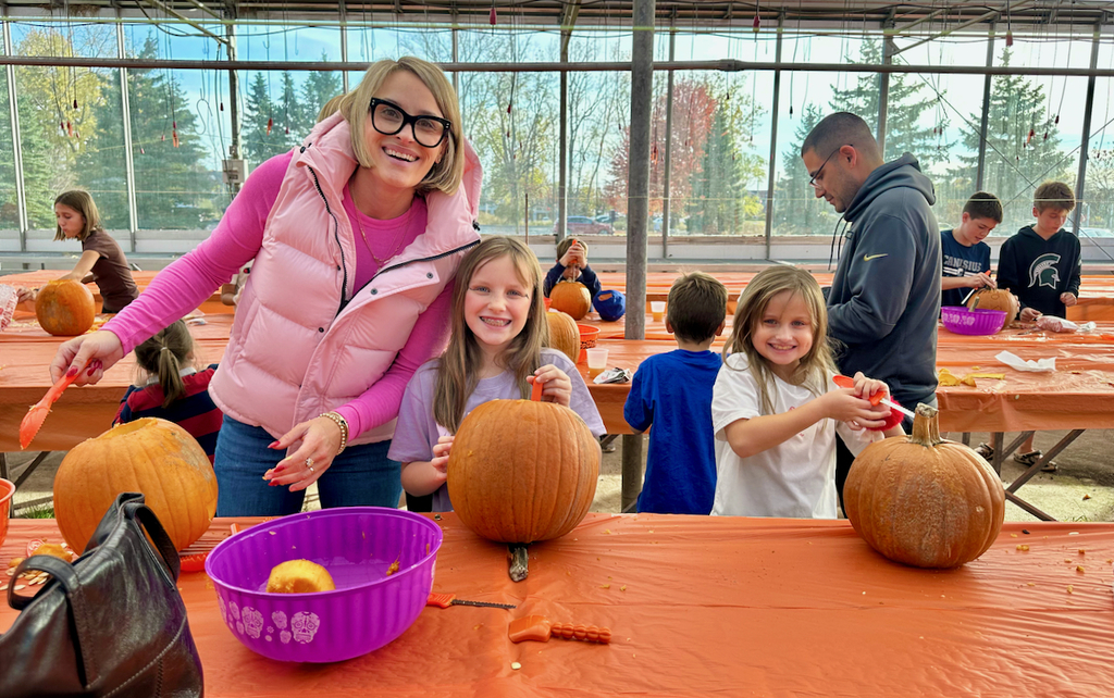 children carving pumpkins