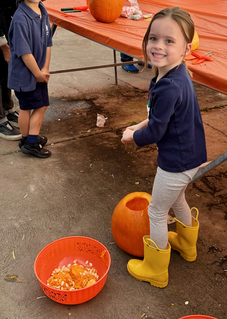 children carving pumpkins