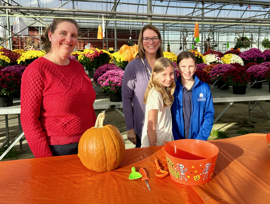 children carving pumpkins