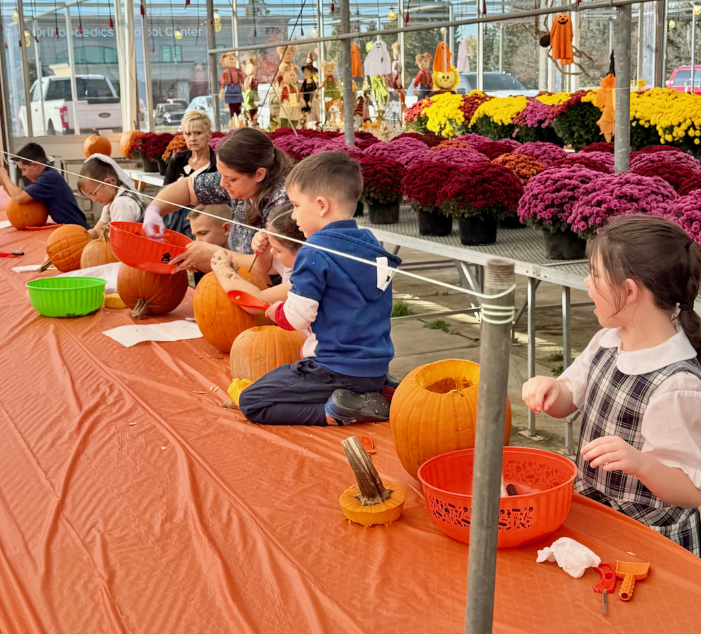 children carving pumpkins