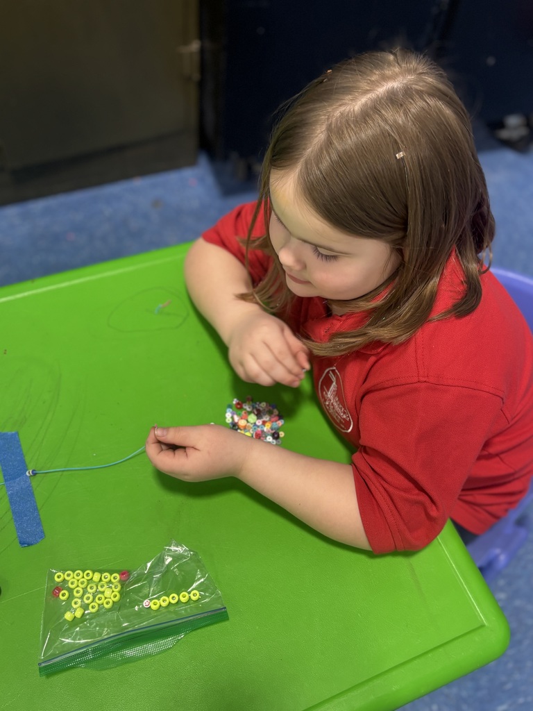 Our students are busy crafting their lucky charm bracelets with lots of focus ... and even bigger smiles!