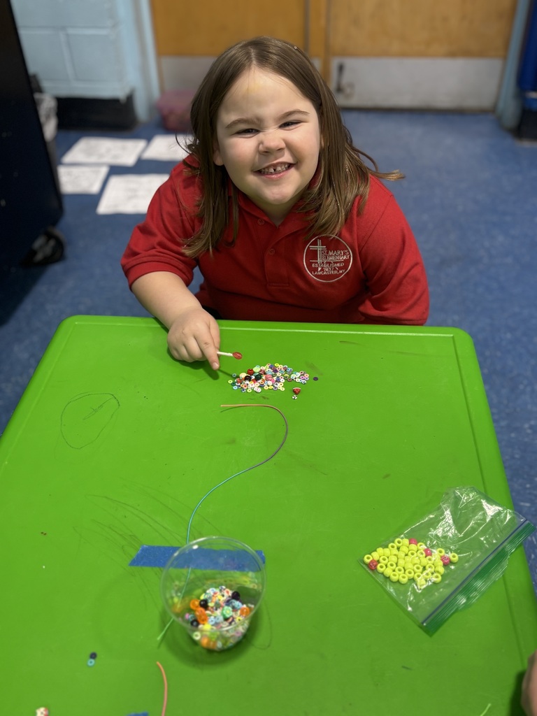 Our students are busy crafting their lucky charm bracelets with lots of focus ... and even bigger smiles!