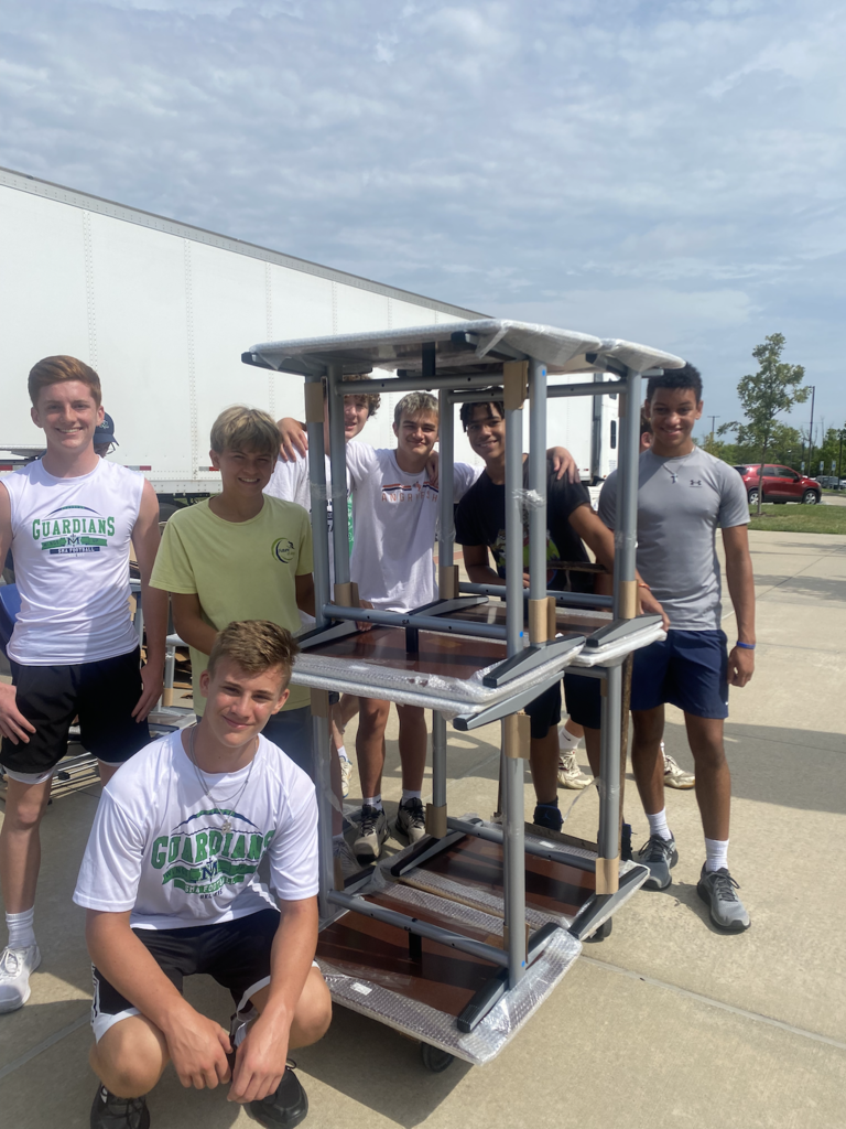 Team unloading chairs