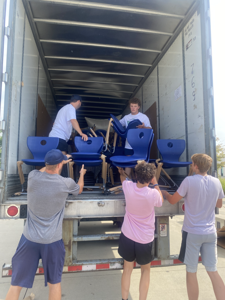 Team unloading chairs