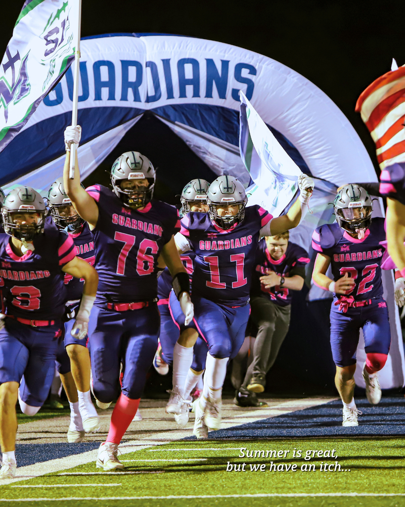 The football team runs out of the tunnel.