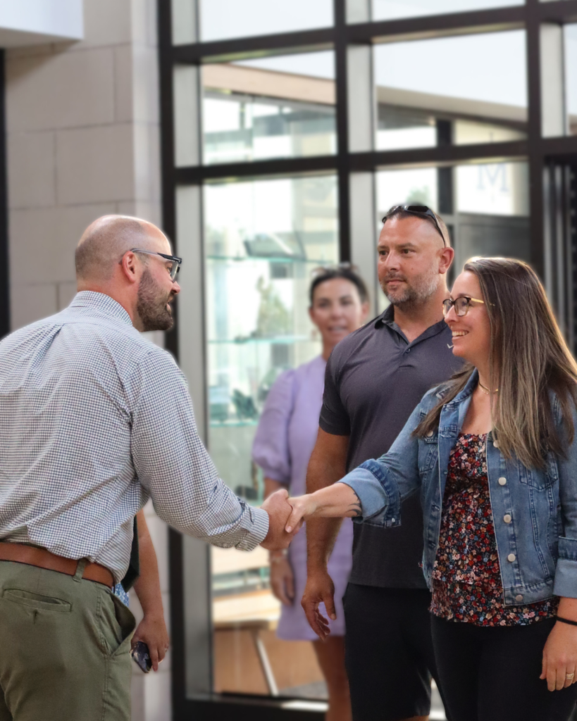 Mr. Molloy shakes a parent's hand.