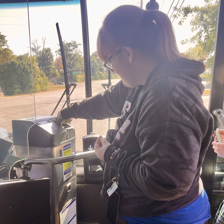 student paying to get in the bus