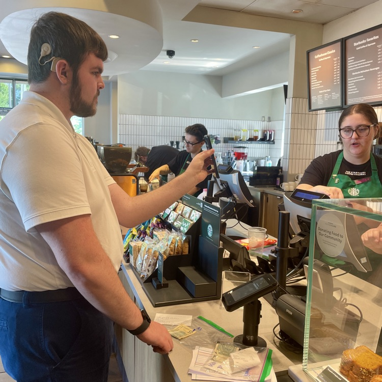 student using his phone to order at Starbucks