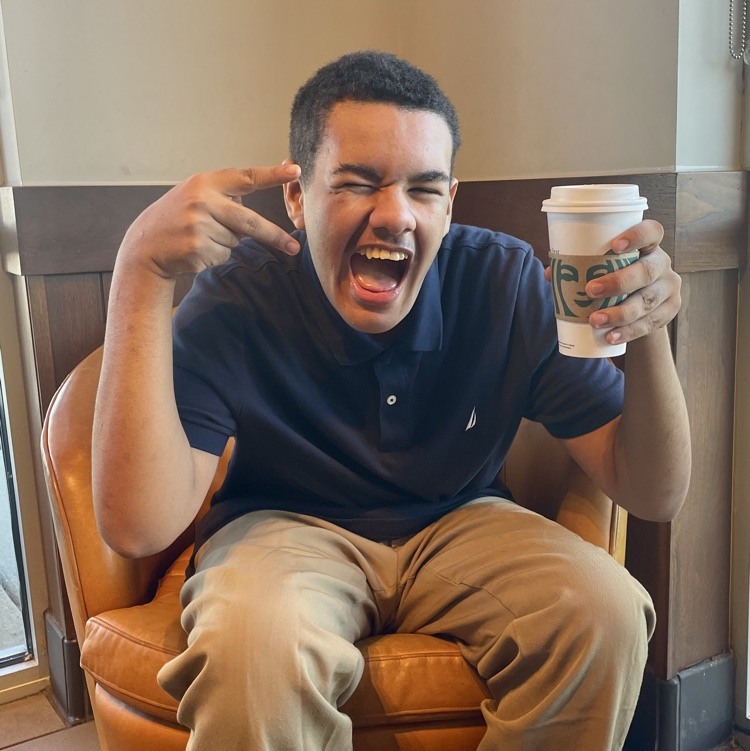 student enjoying his coffee at Starbucks