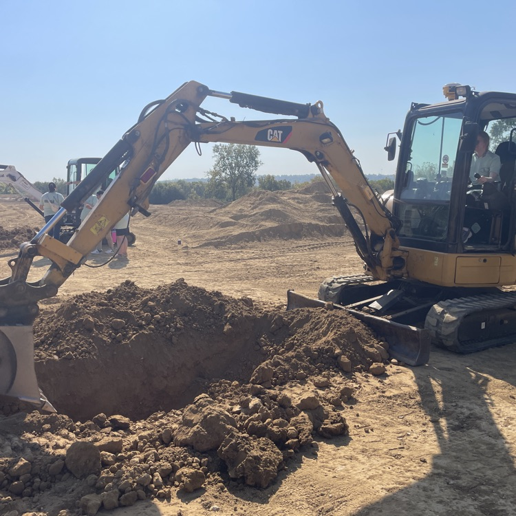 Student operating a digger