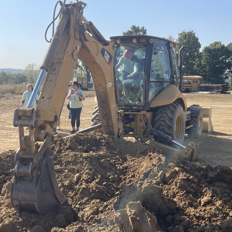 Student operating a digger