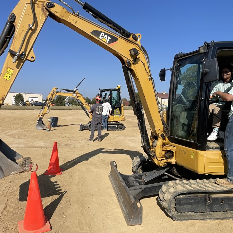 Student operating construction equipment 