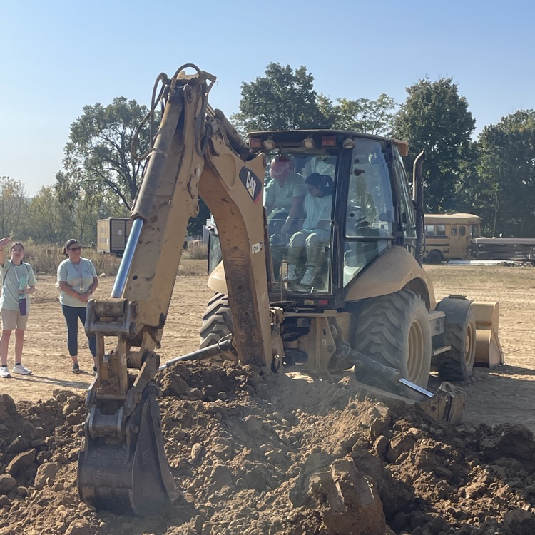 Student operating construction equipment