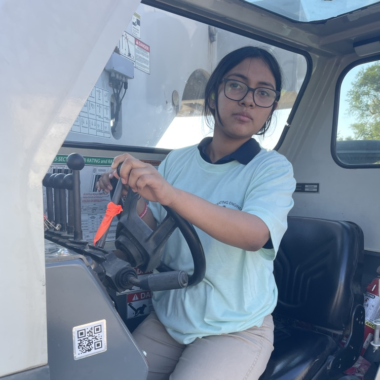 Student operating construction equipment