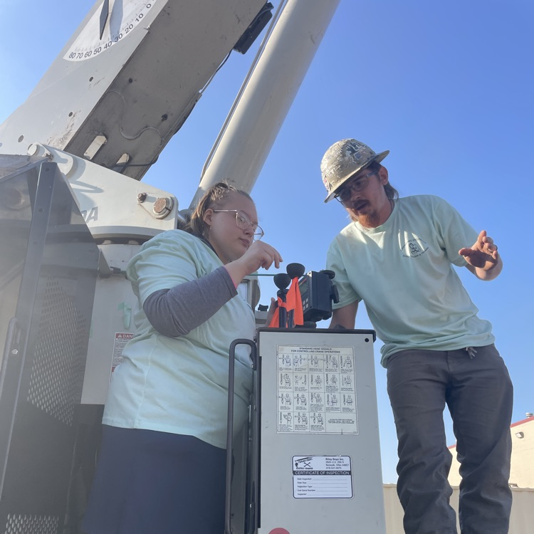 Student operating construction equipment