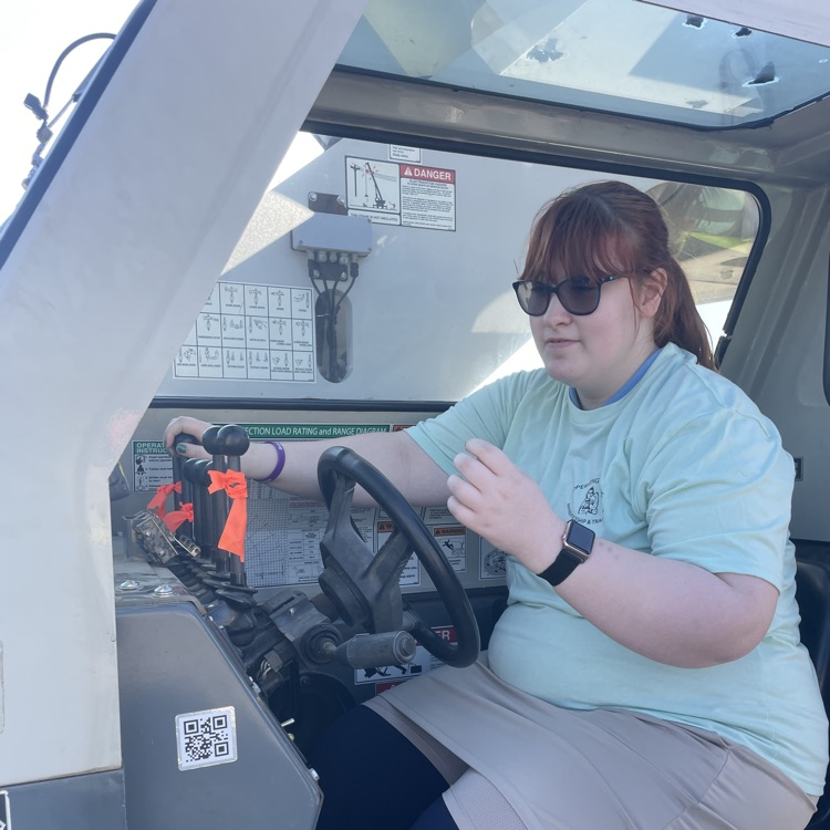 Student operating construction equipment