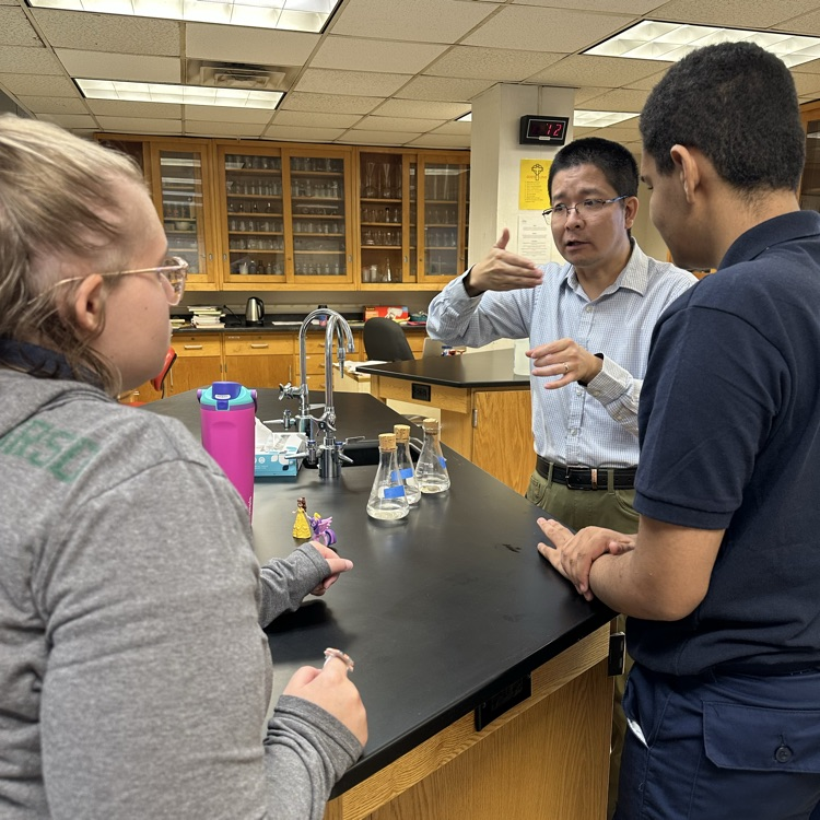 Teacher is instructing how to use senses to identify a sample liquid  