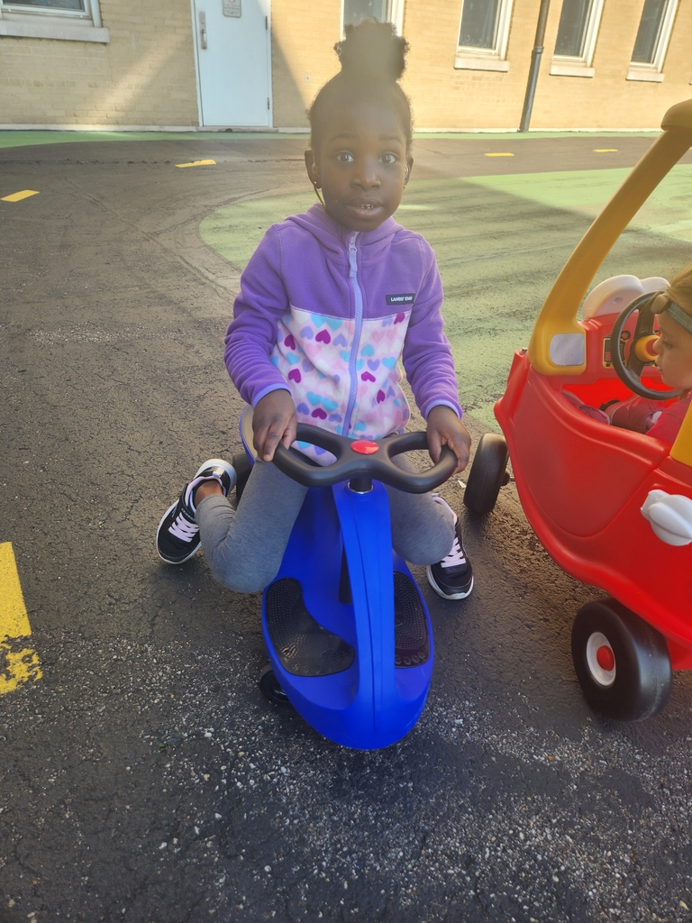 A student girl sitting a on a blue scooter.