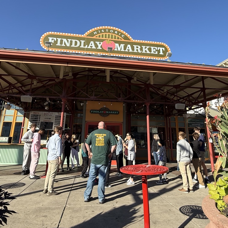 Bright Sunny Day at Findlay Market surrounded in downtown Cincinnati. Group of student standing near the main entrance.