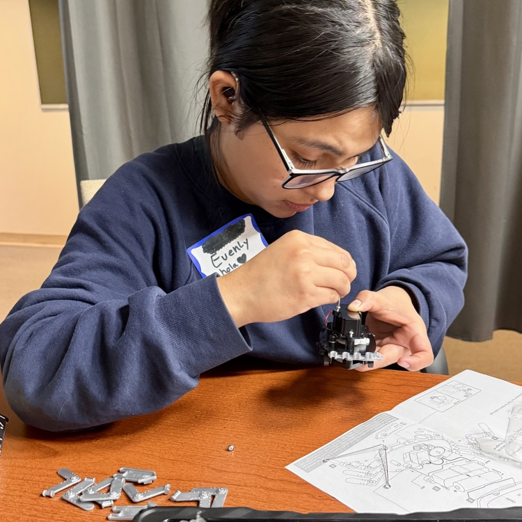 a student is following directions to put together a robot
