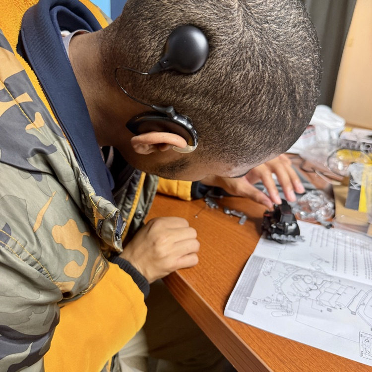 a student is following directions to put together a robot