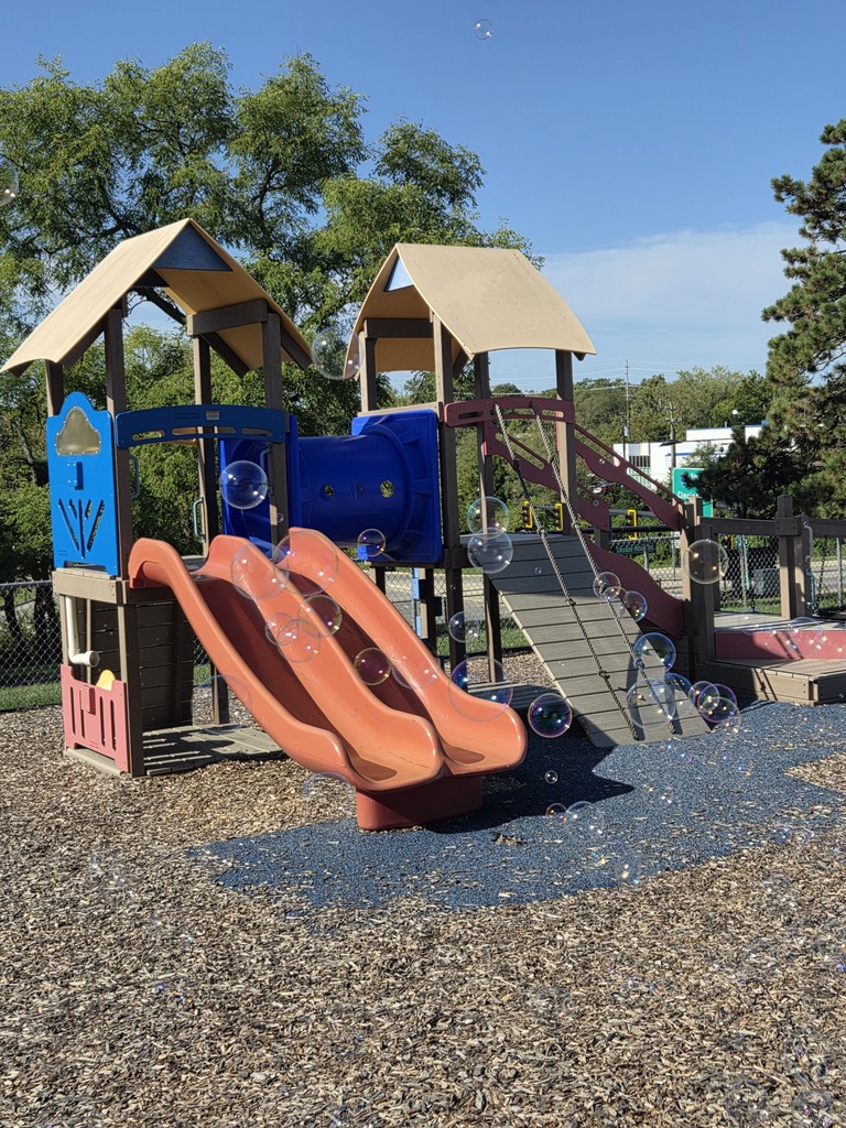 Picture: playground enquipement with bubbles floating around it.