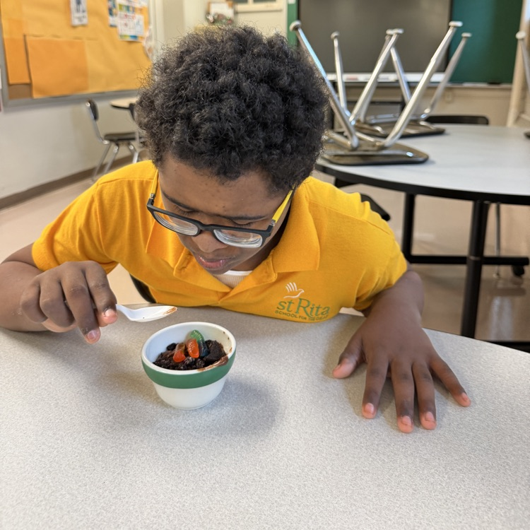 a student is eating pudding in home ec