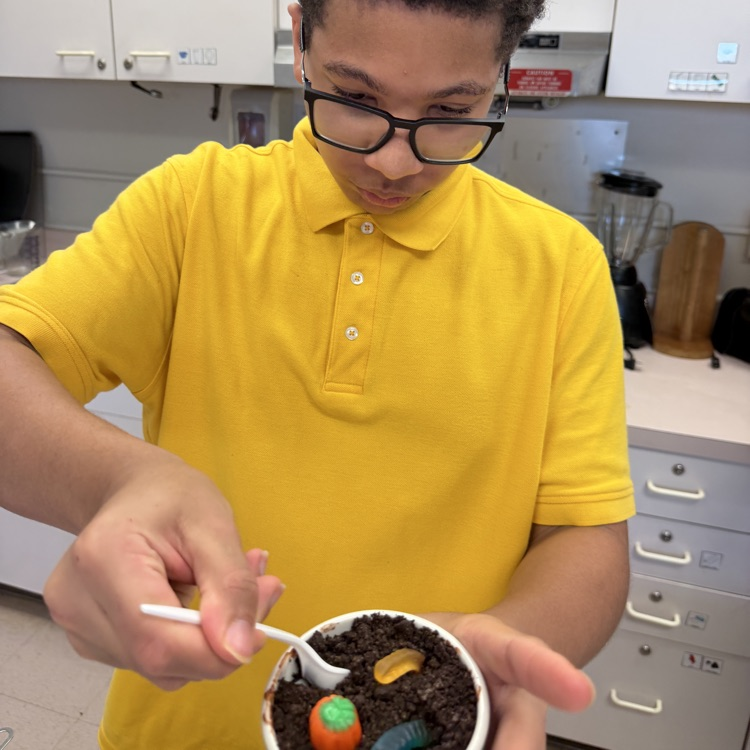 a student is eating his pumpkin patch dirt cup