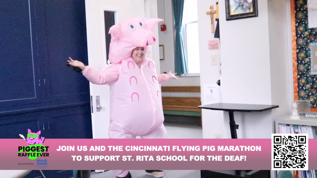 Angie in the pig suite. Join us and the Cincinnati Flying Pig Marathon to support. St. Rita School for the Deaf!