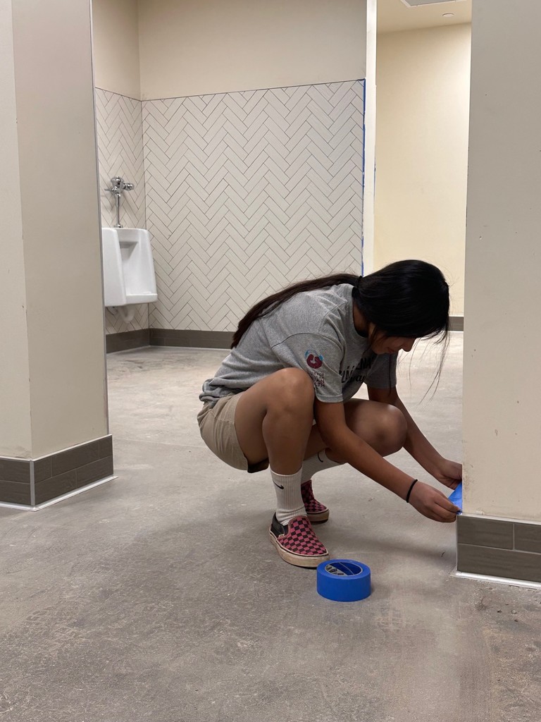 taping around the baseboard tiles
