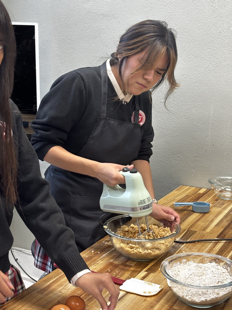 Student making oatmeal cookies