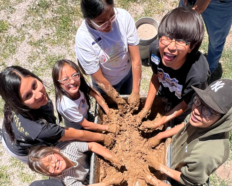 Students making mud mixture