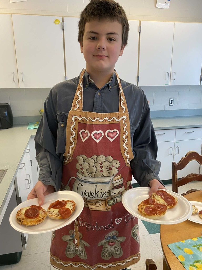 kid holding a plate of pizza muffins 