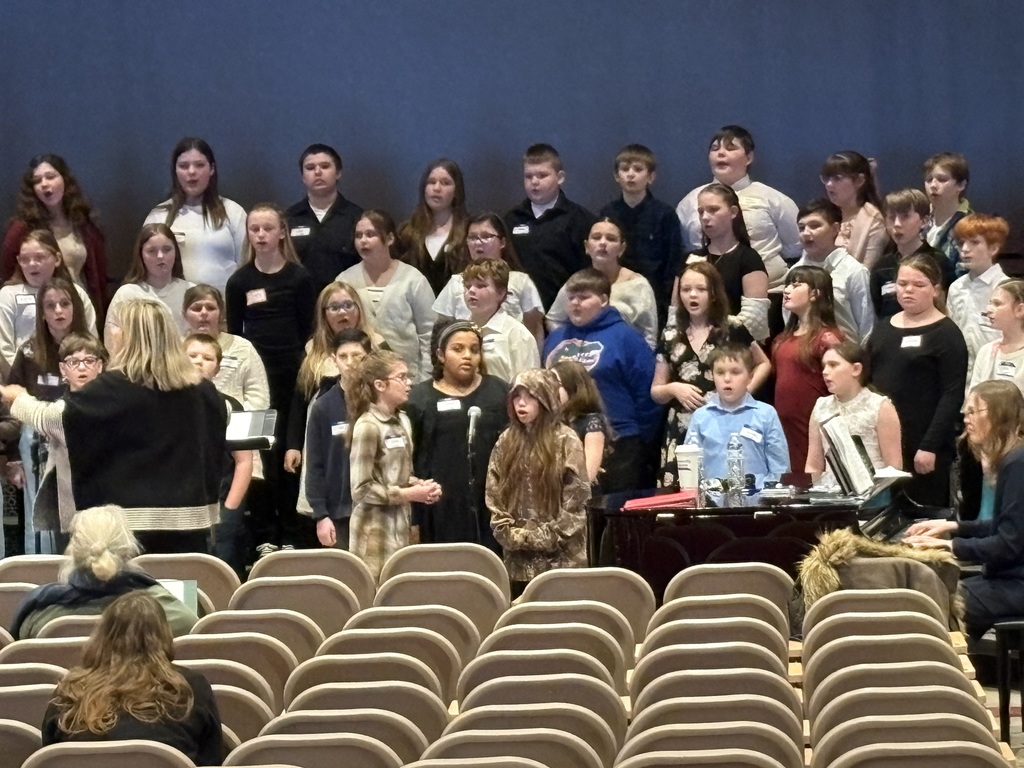 kids singing in an auditorium