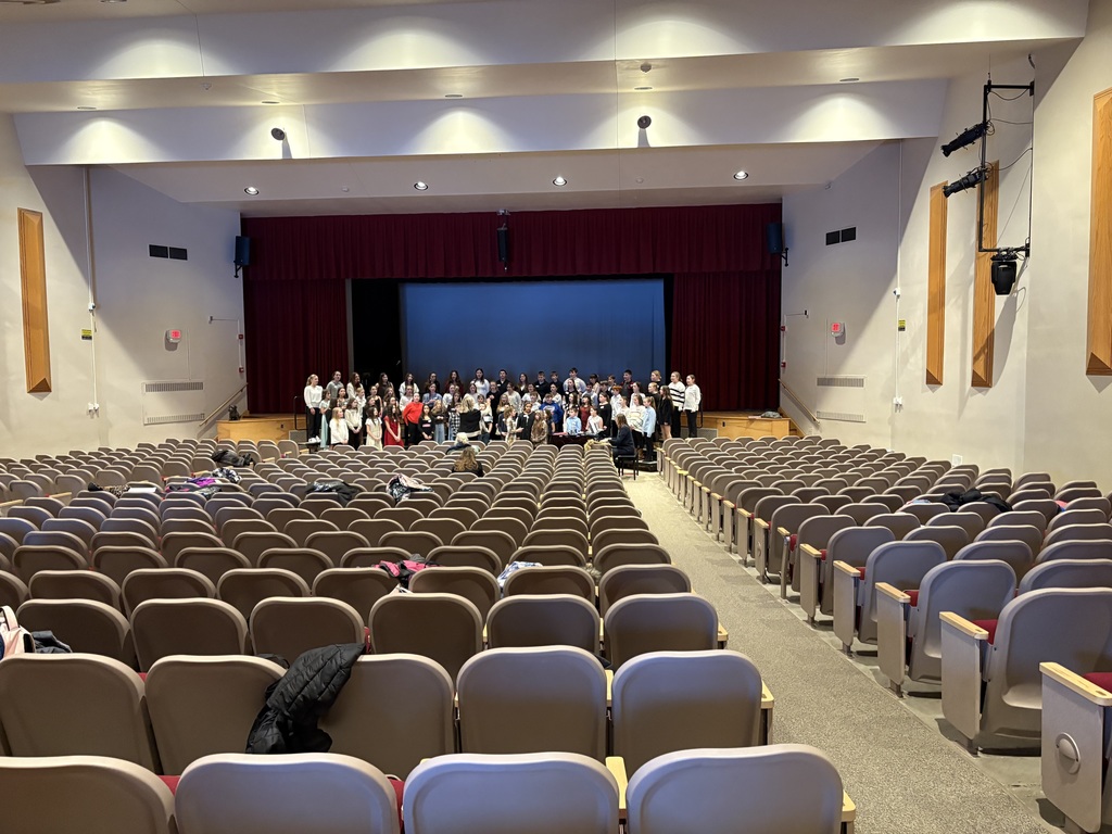 Kids standing in an auditorium
