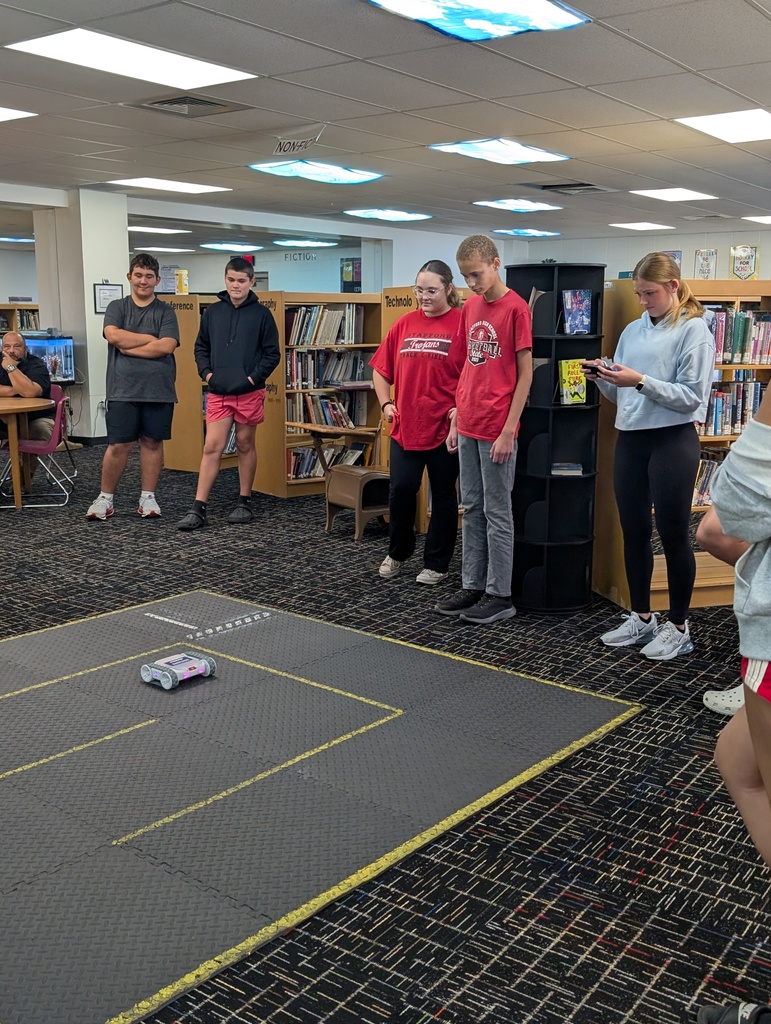 Students maneuvered the robot through the "factory" without running into shelves.