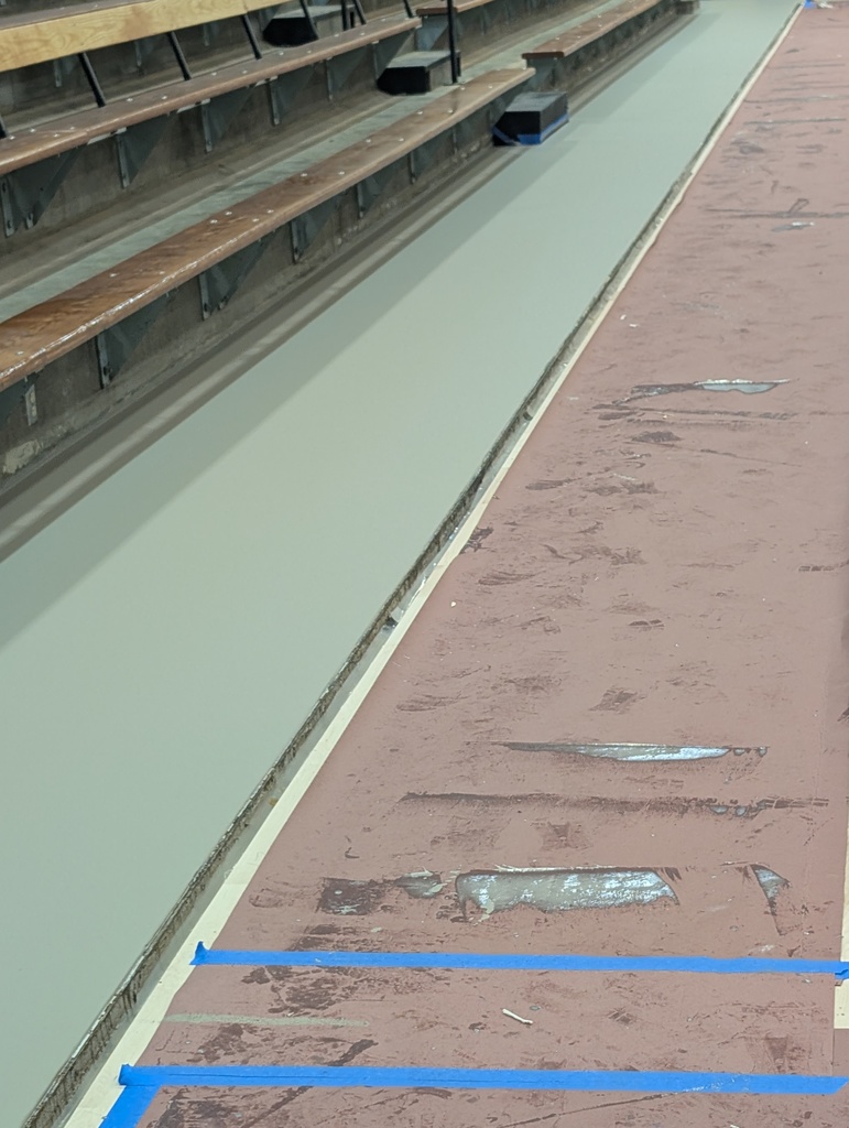 Instead of tile, the area surrounding this floor is a rubber / polyurethane flooring. It takes up to a week to fully cure. 
