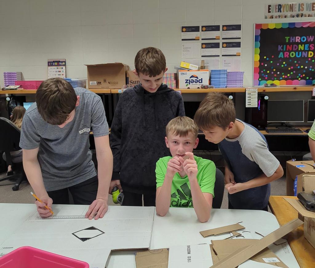 4 middle school boys creating a prototype 