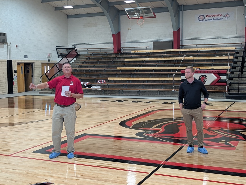 Coaches inspecting the floor.