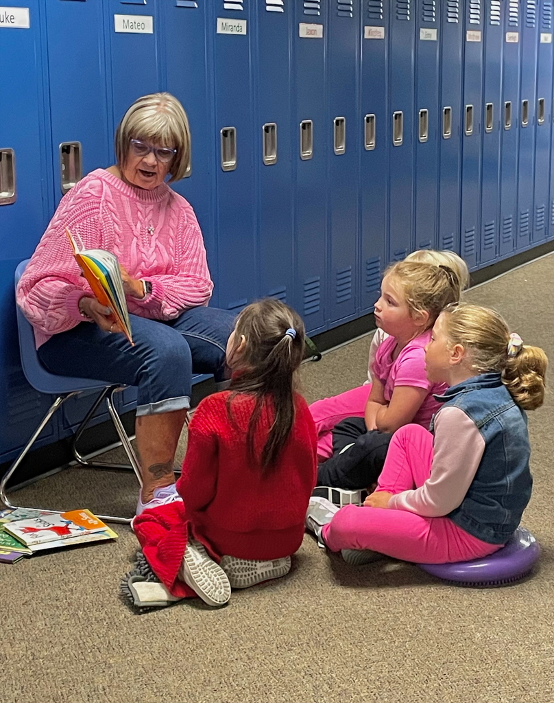 Teacher reading a book to students