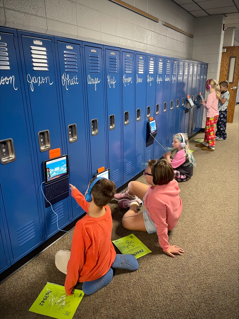 students in a hallway reading on their iPads