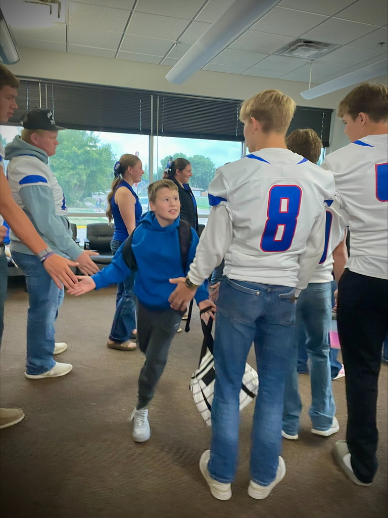 football players greeting students