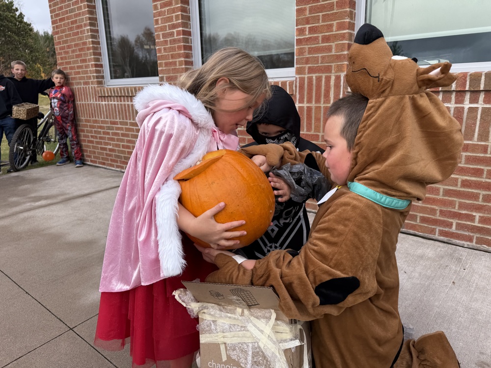 Students checking their pumpkin for damage.