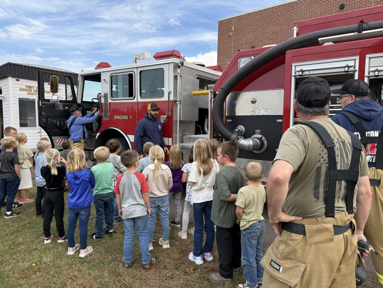 Students outside fire truck.