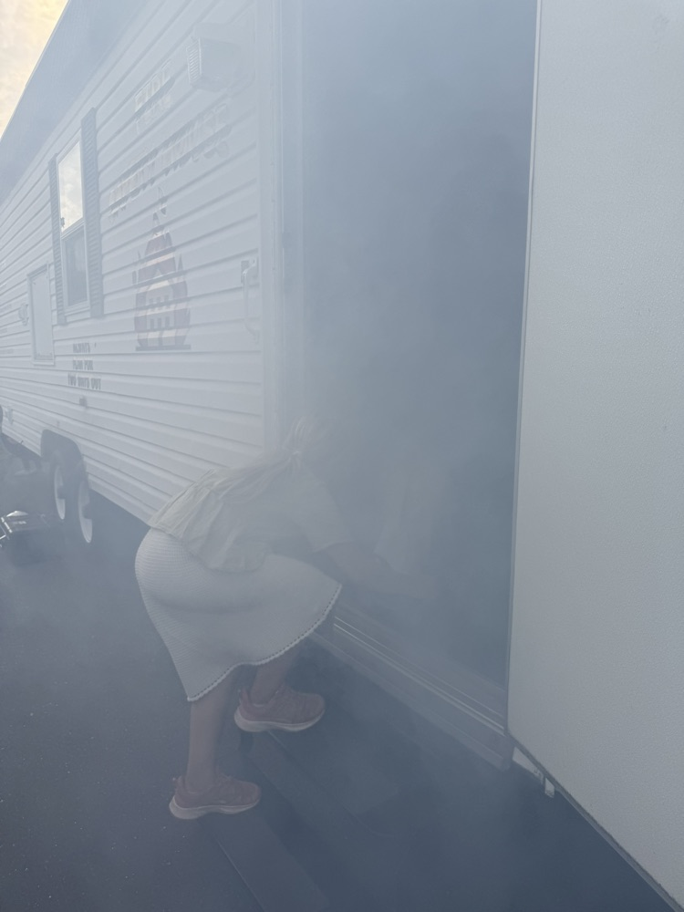 Students entering smoke house demo.