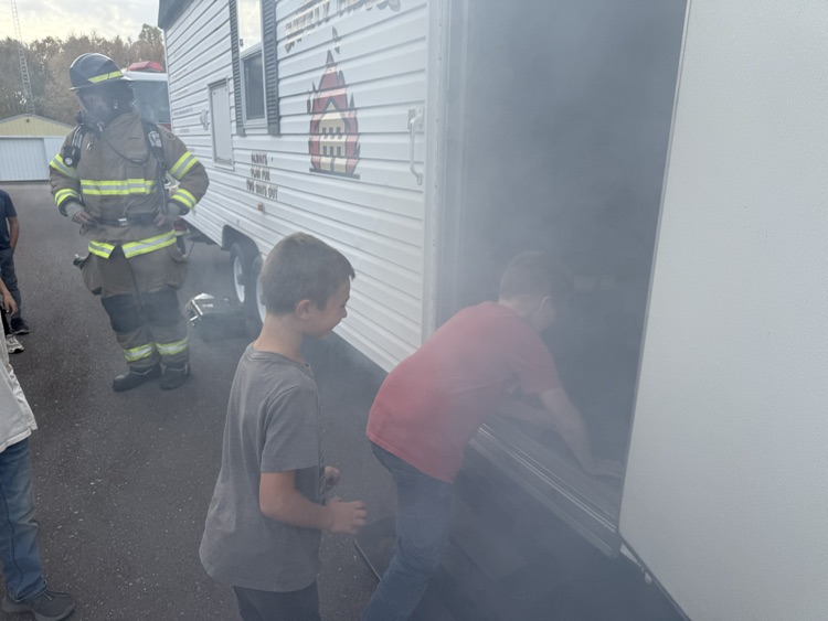 Students experiencing the smoke house demo.