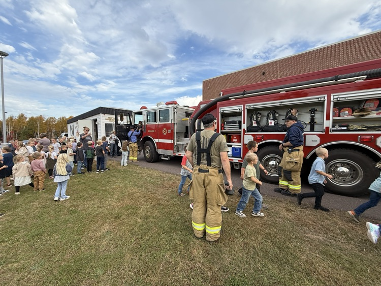 Students outside fire truck.