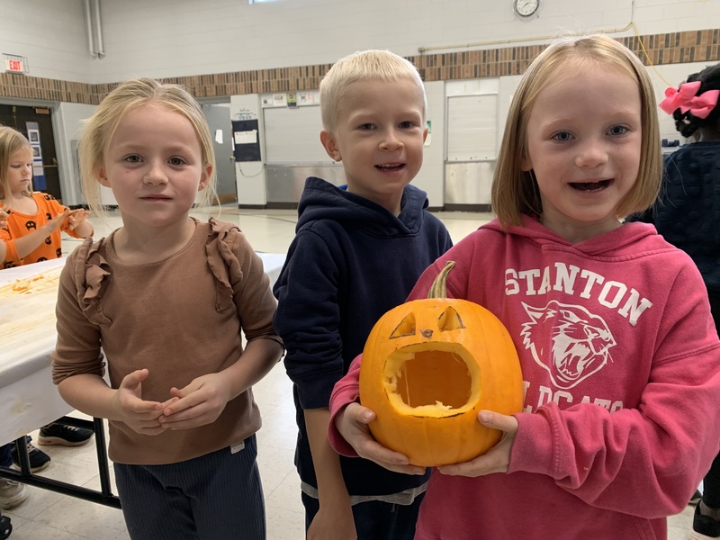 Students with jack o’ lanterns.